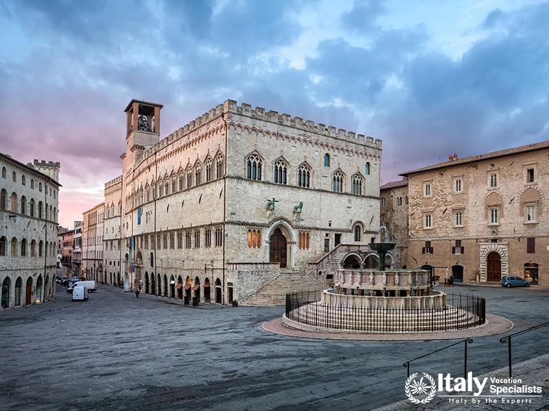 Perugia, Italy Medieval aqueduct and colorful buildings at dusk