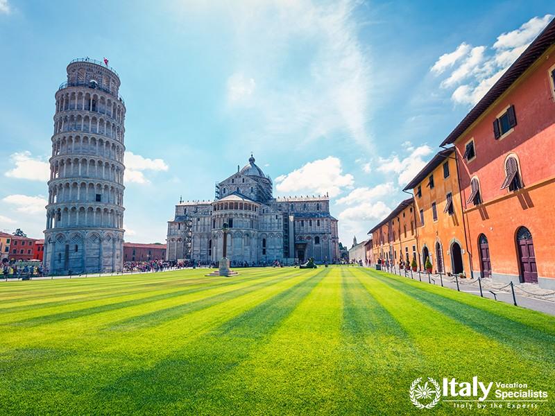 Beautiful spring view of famous Leaning Tower in Pisa. Sunny morning scene with hundreds of tourists