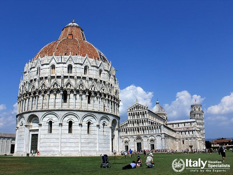 Baptistery of Pisa, the biggest in Italy. Pictures and relax for tourists in a beautiful summer day.