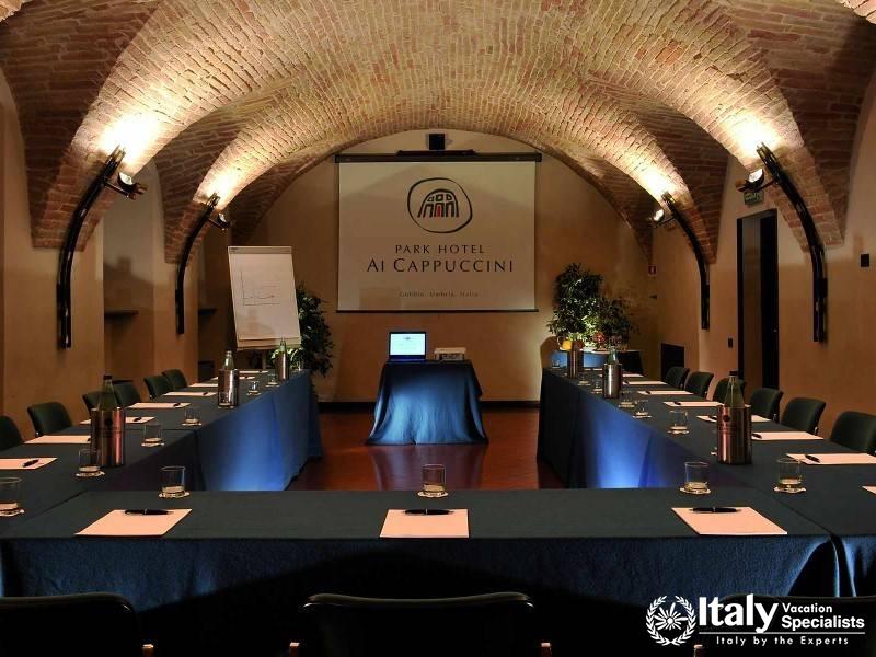 Well-equipped meeting room with historic brick arches, ideal for seminars and conferences.