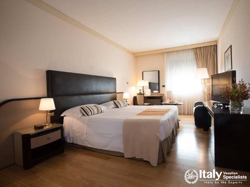 A bright and modern bedroom with sleek design elements, offering a serene retreat.