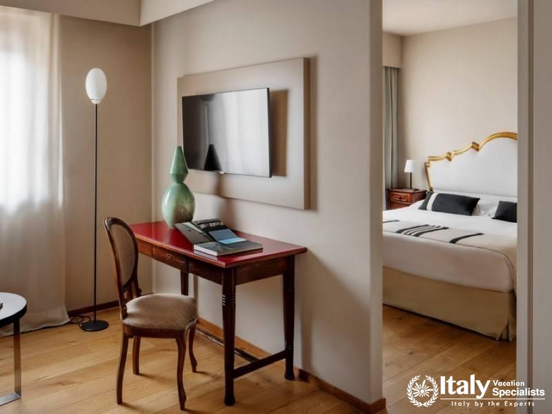 Well-lit room featuring a stylish desk setup, ideal for business or leisure.