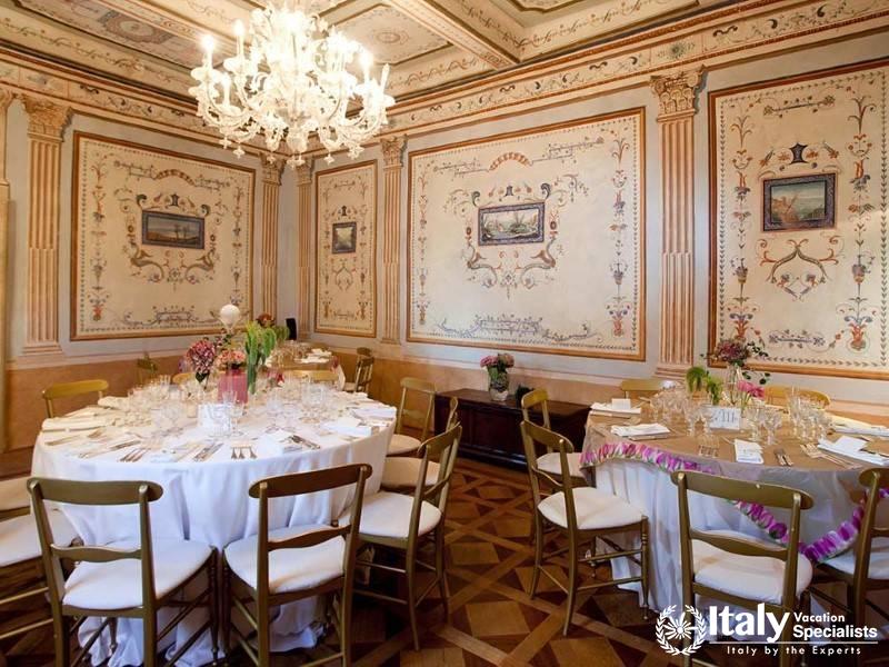 Exquisitely detailed dining room with ornate frescoes and a grand chandelier.