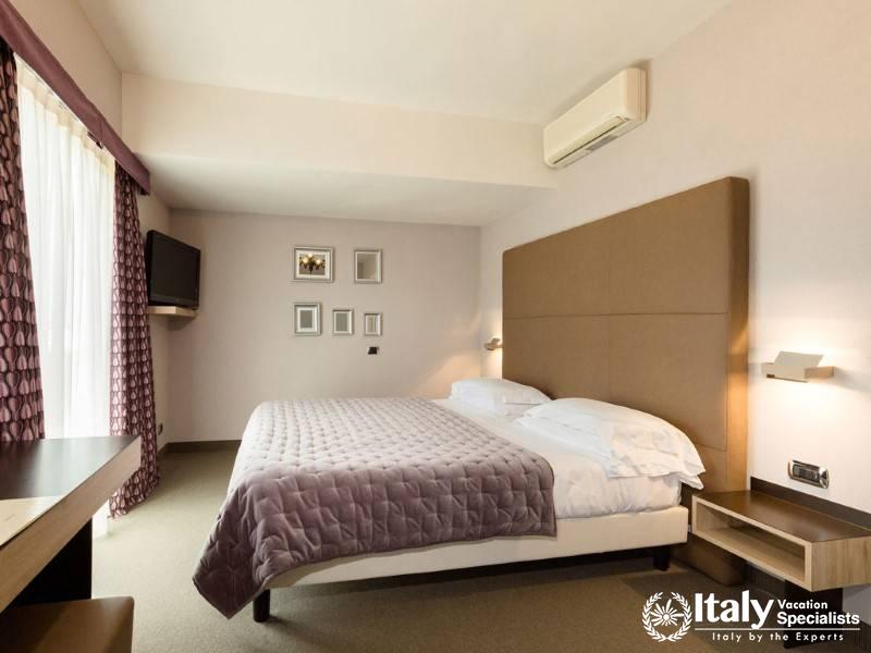 A modern, comfortable suite with a cozy bed and minimalist design in soft, neutral tones.