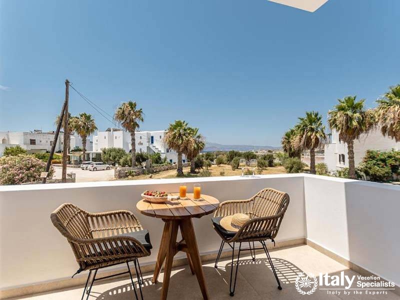 Enjoy a peaceful moment on the balcony at Perla Hotel in Naxos, Greece
