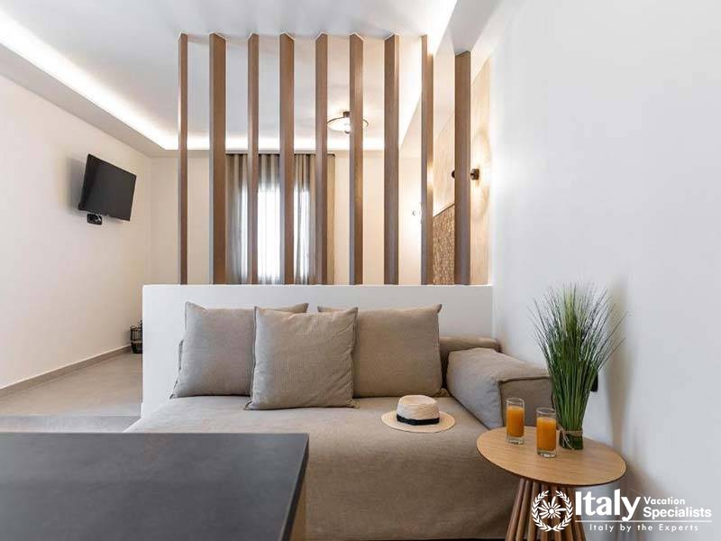 Cozy lounge area with a modern partition at Perla Hotel in Naxos, Greece