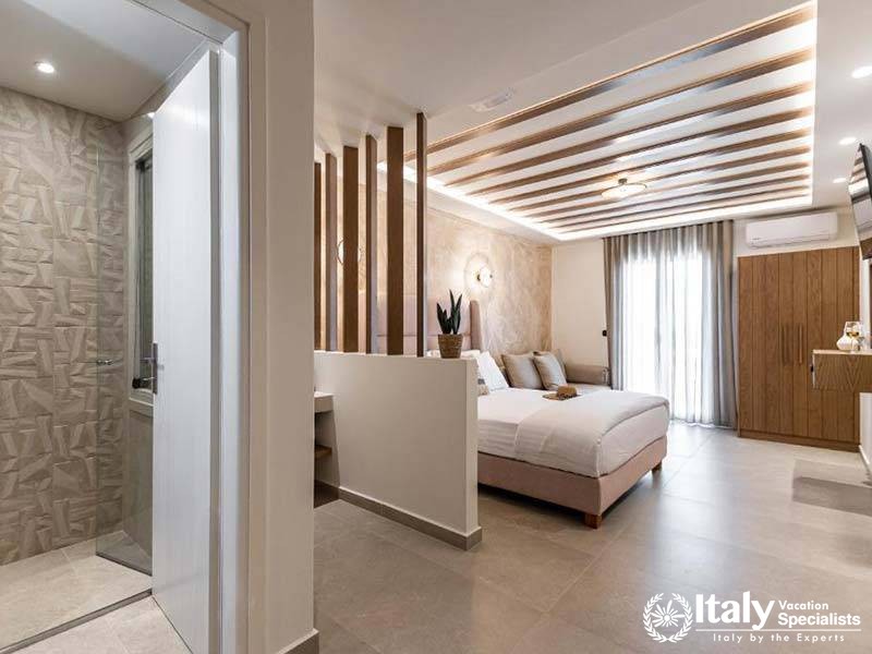 Elegant bedroom with stylish decor at Perla Hotel in Naxos, Greece