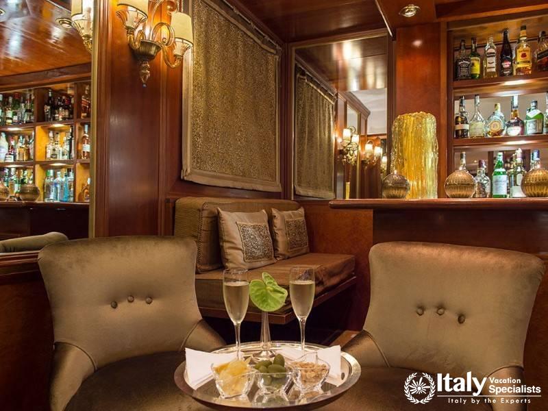 Cozy, elegant bar with plush seating and a well-stocked display.