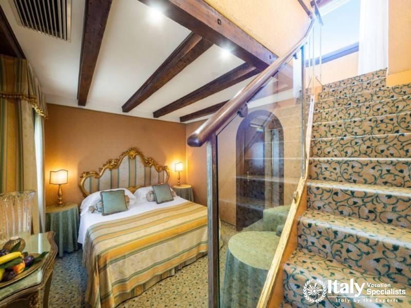 Luxurious bedroom featuring a spiral staircase and exposed wooden beams.