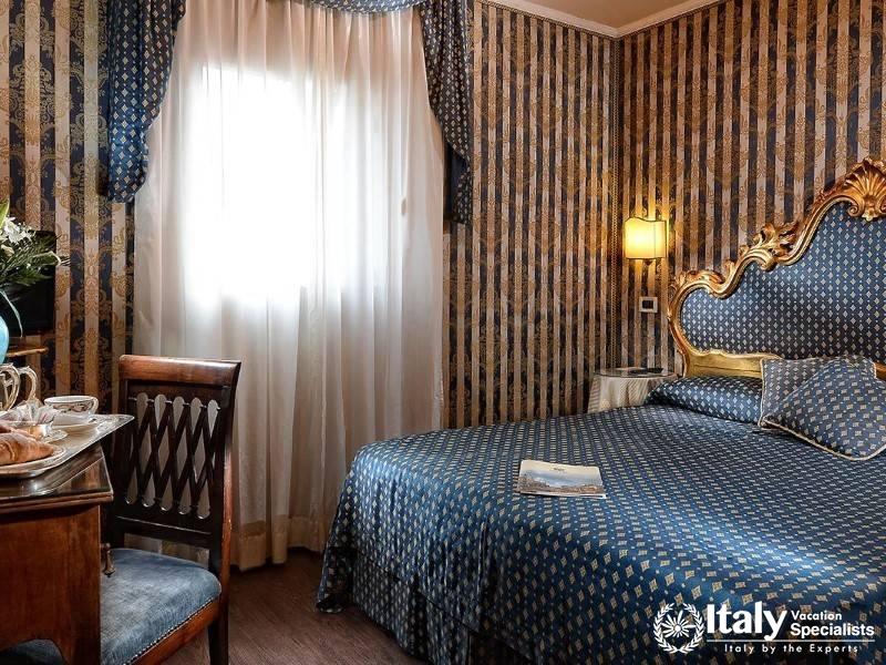 Charming bedroom with royal blue and gold decor, giving a regal ambiance.