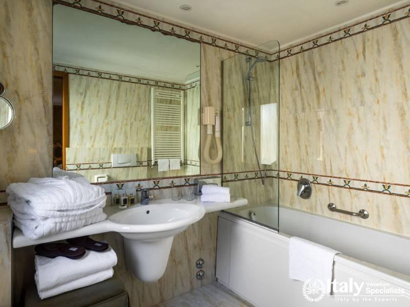 Bright bathroom with marble finishings and modern amenities.