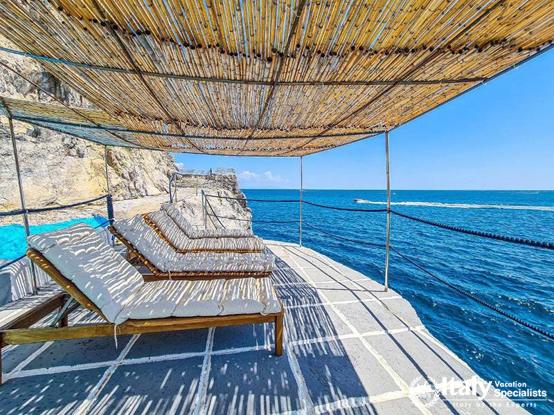 Shaded Lounge Area by the Sea in Villa Bellissima Vista Mare in Campania, Italy