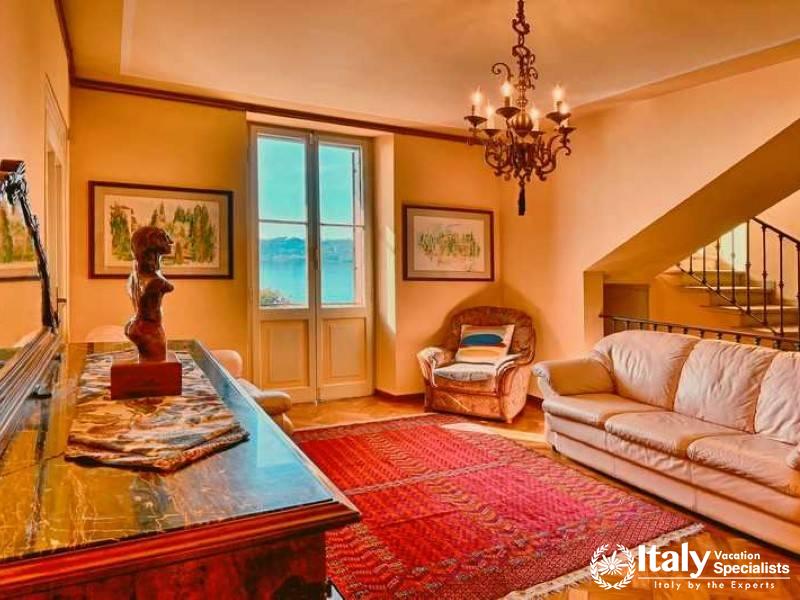 Sophisticated Living: An elegant living space with lake views, warm tones, and tasteful art  in Lago