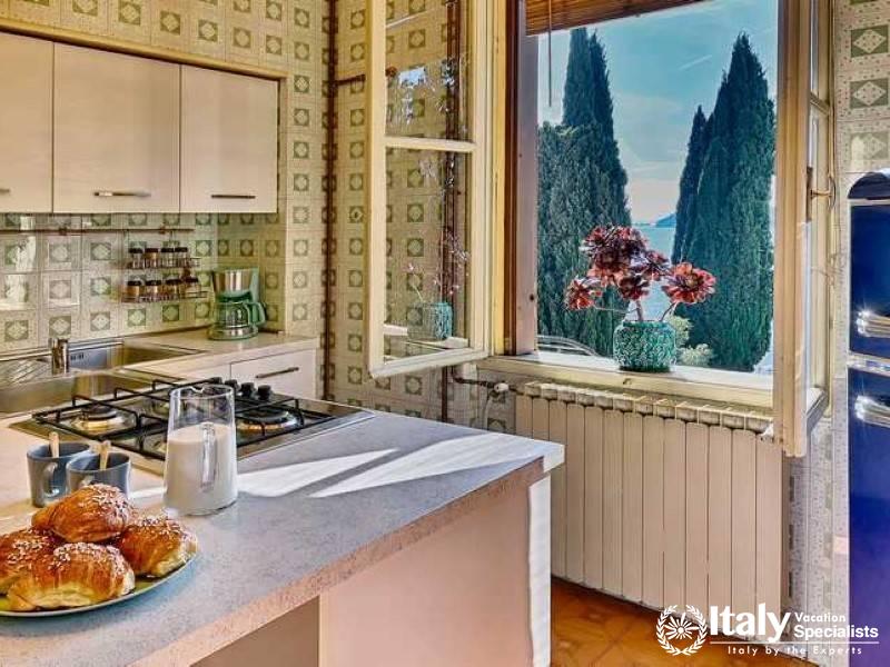 Culinary Charm: A quaint kitchen with vintage flair overlooking the serene cypress-lined shore