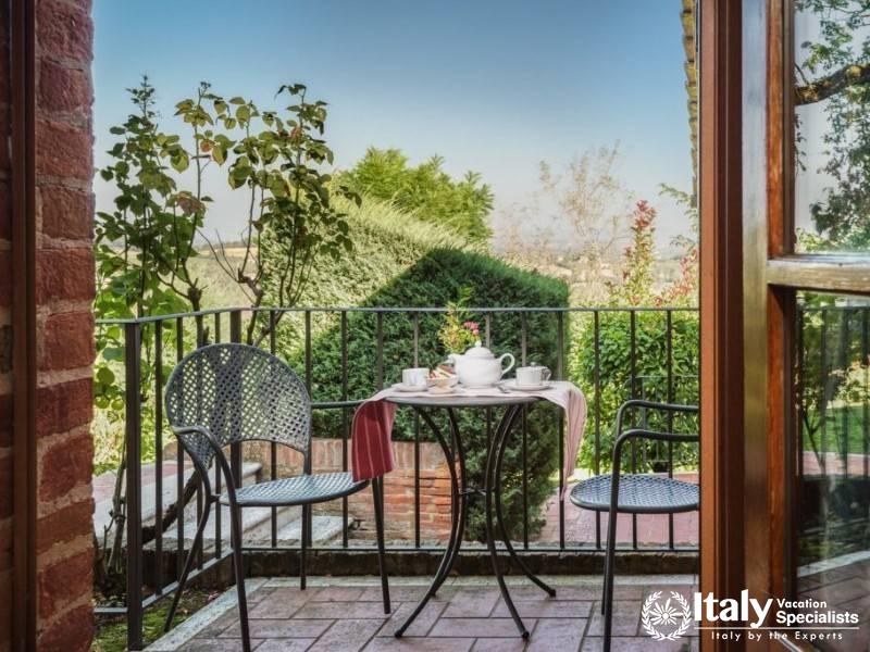 Inviting balcony setting with a table for two, perfect for a morning coffee overlooking the garden.