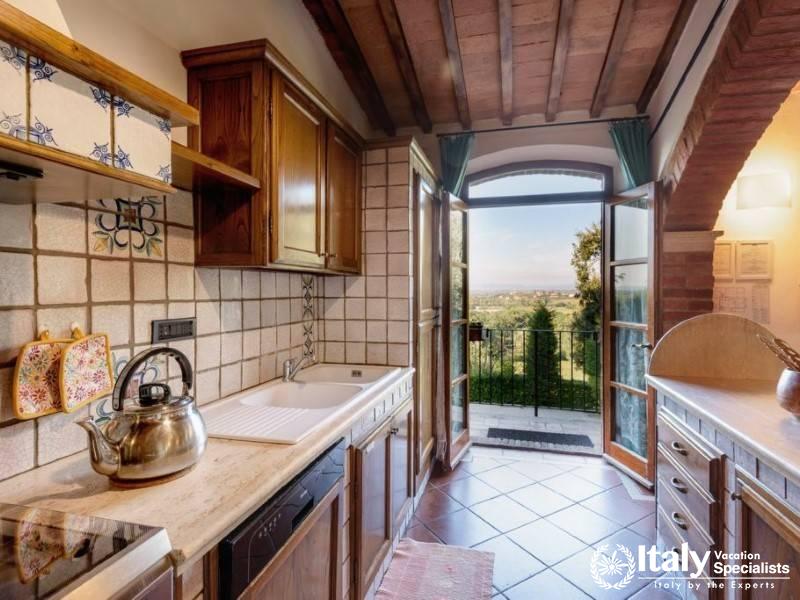Classic wooden cabinetry and a ceramic backsplash, with a scenic window view.