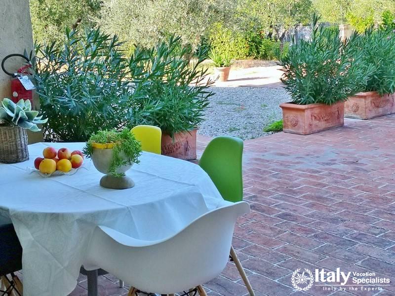 Outdoor dining area with garden view near Florence, Italy.