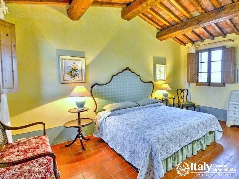 Spacious Bedroom: Bright bedroom with vintage bed and elegant decor.