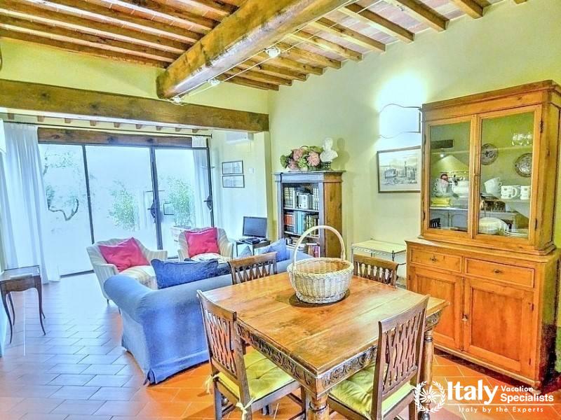 Living Area: Comfortable living space with wooden beams and classic furniture.