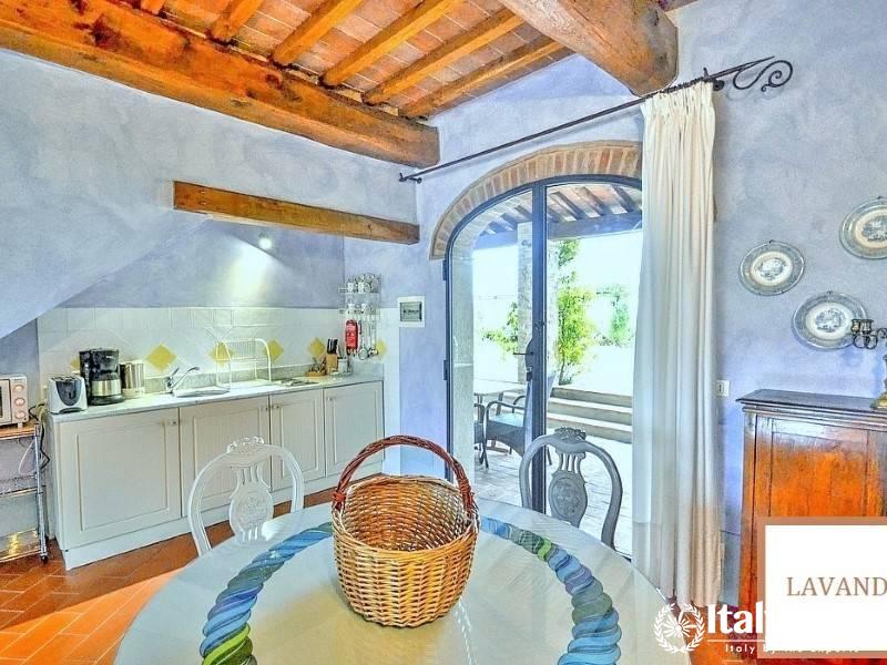 Cozy dining area with an arched doorway leading to an outdoor patio.