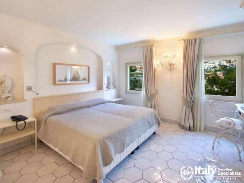 A bright and airy bedroom with elegant decor and lovely views.