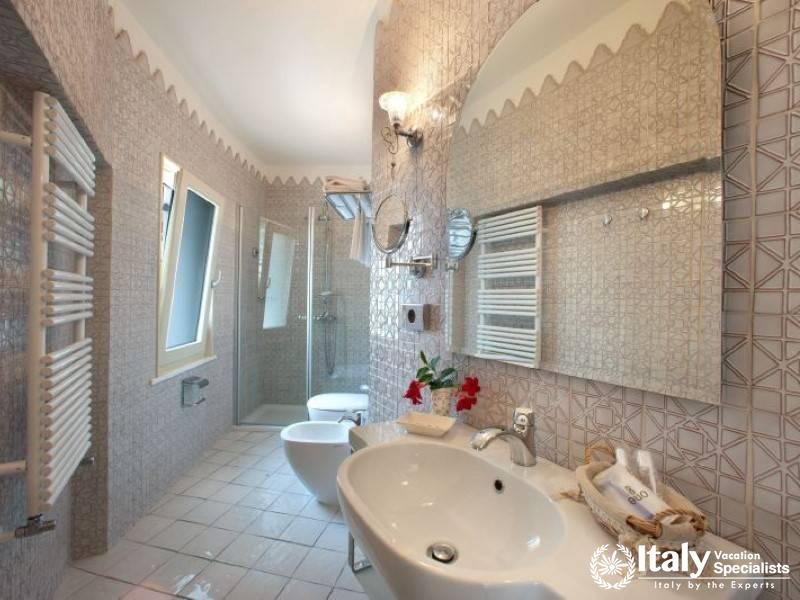 A modern and stylish bathroom with intricate tile work and luxury fittings.