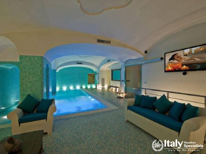 An elegant indoor pool area with ambient lighting and comfortable seating.