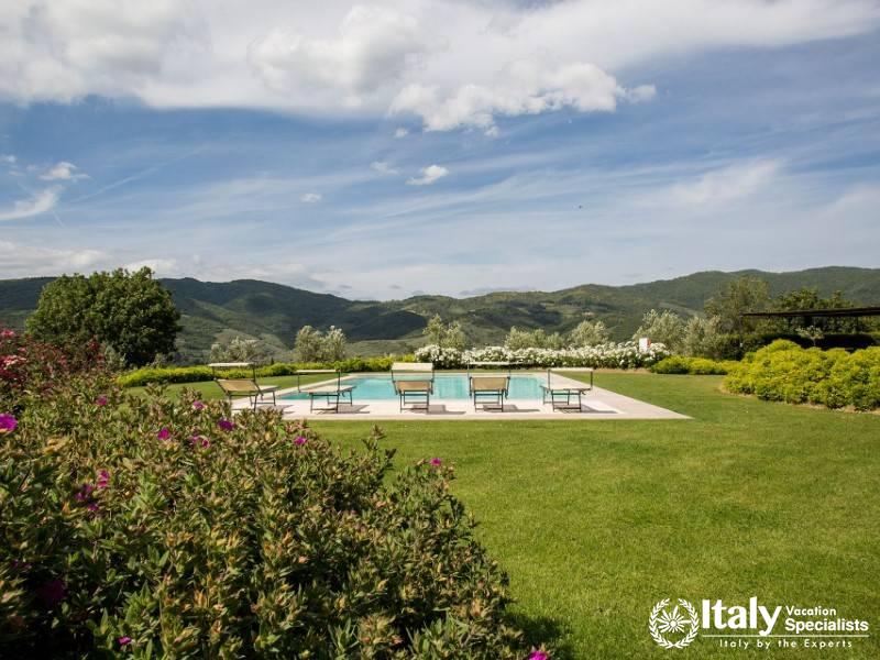 Tranquil swimming pool with stunning mountain backdrop.