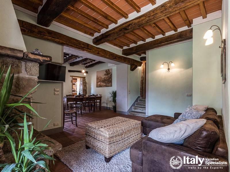Comfortable living area with exposed beams and rustic charm.