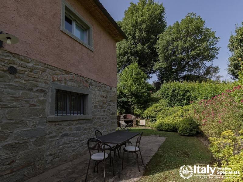 Outdoor Dining: Serene outdoor dining area in a lush garden.