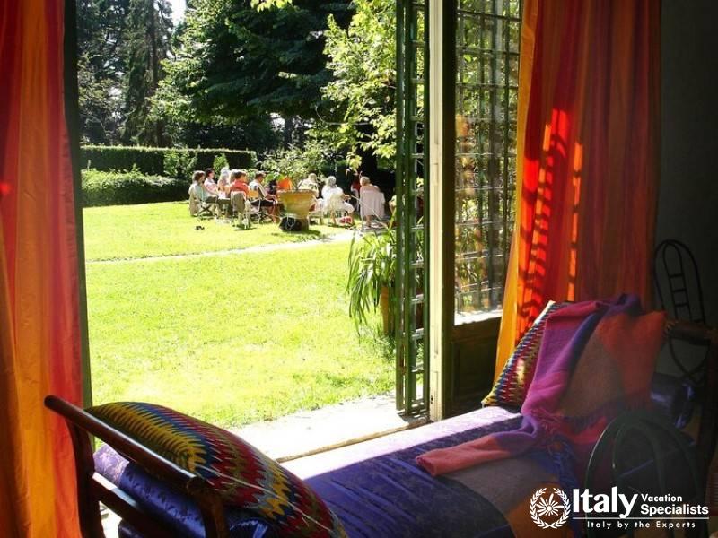 View from a colorful room to an outdoor garden gathering.