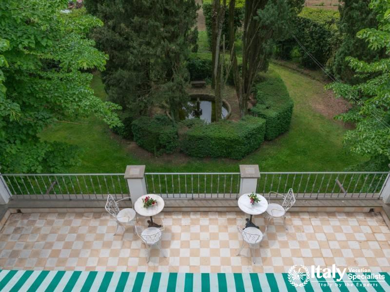 Aerial view of a garden patio with small round tables and chairs.