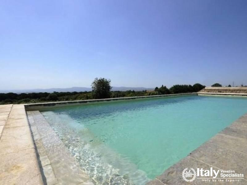 Serene swimming pool with a view of the countryside.