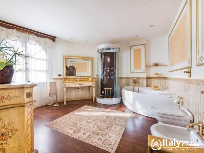 Opulent bathroom featuring a jacuzzi tub and modern shower.
