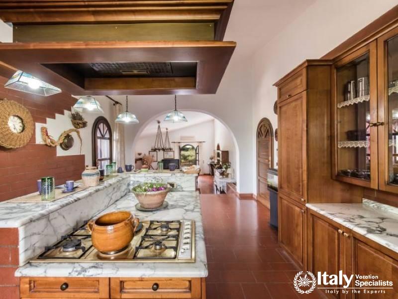 Open-plan kitchen leading to a cozy living area, perfect for relaxation.