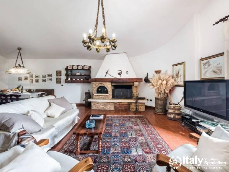 Cozy living room with a charming fireplace and rustic decor.