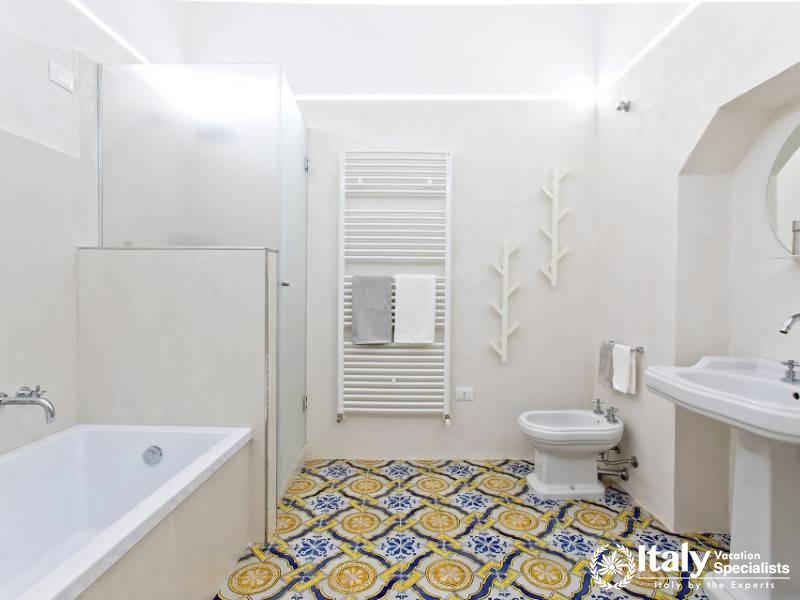 Villa Sole di Marsala features a modern bathroom with traditional Sicilian tiles.