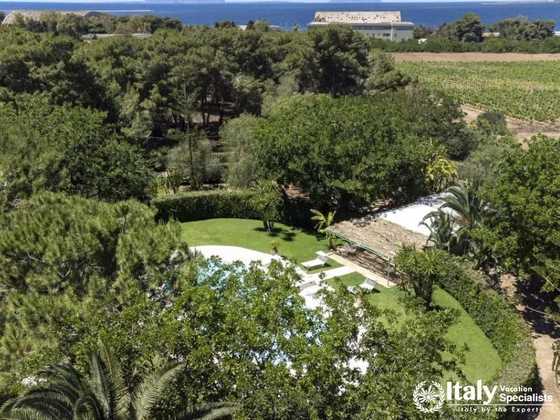 A stunning aerial view of Villa Sole di Marsalaâ€™s pool and lush gardens.