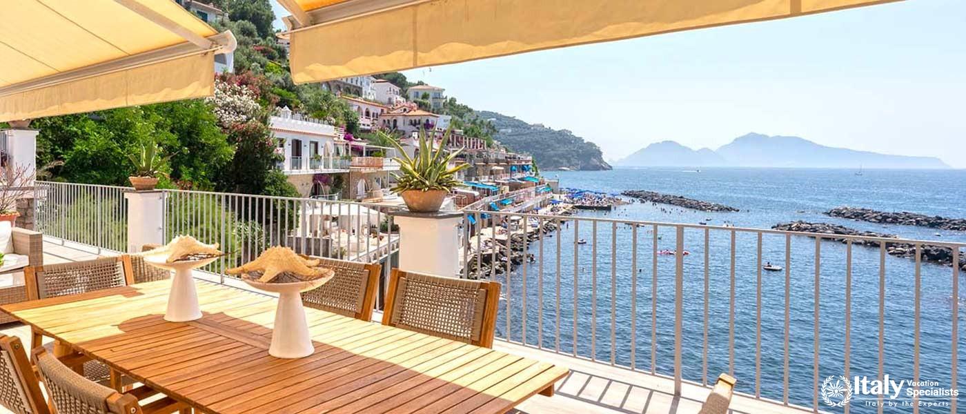 An inviting outdoor dining area with a spectacular view of the ocean and coastline.
