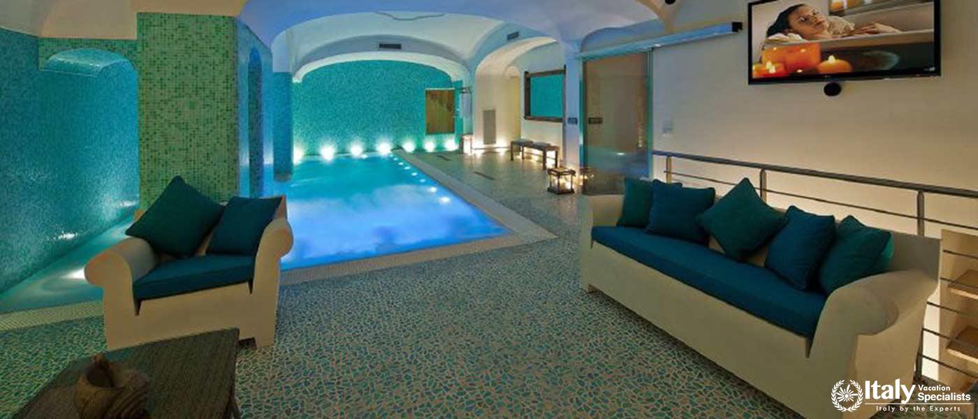 An elegant indoor pool area with ambient lighting and comfortable seating.