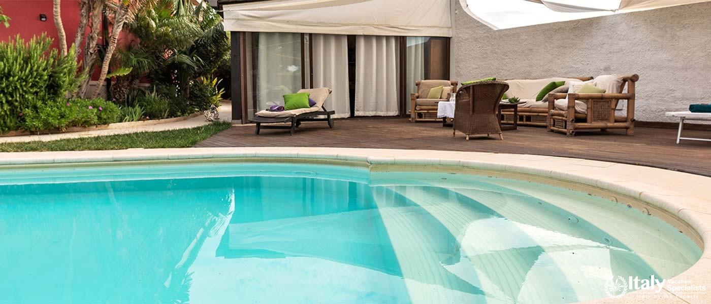Shaded lounge by the pool for relaxing in comfort.