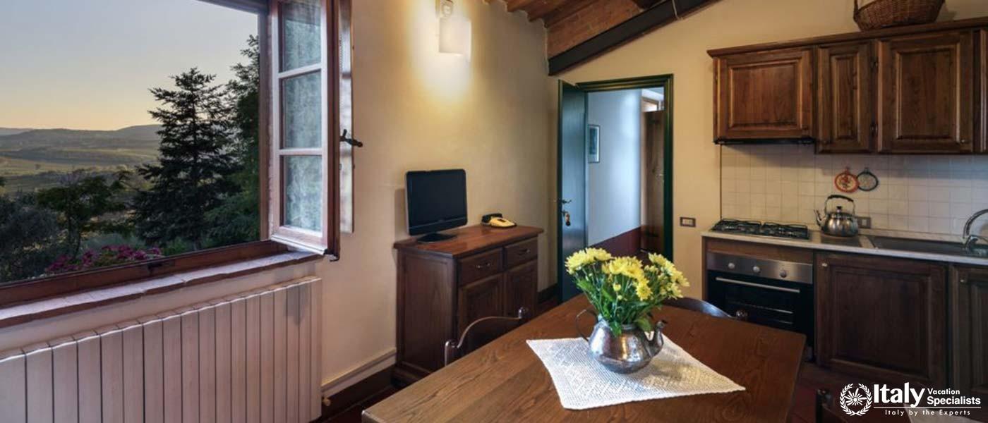 A quaint kitchen and dining area with a view of rolling hills, offering a serene spot for morning.
