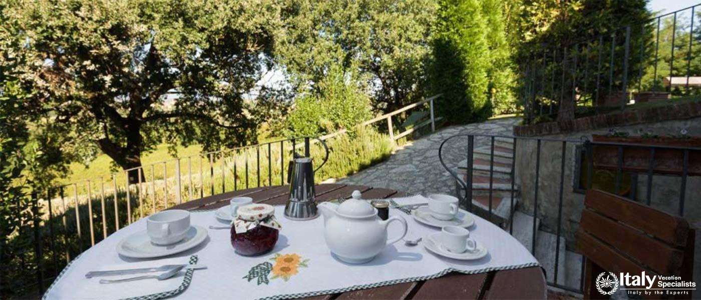 A serene outdoor breakfast setting overlooking a verdant garden.