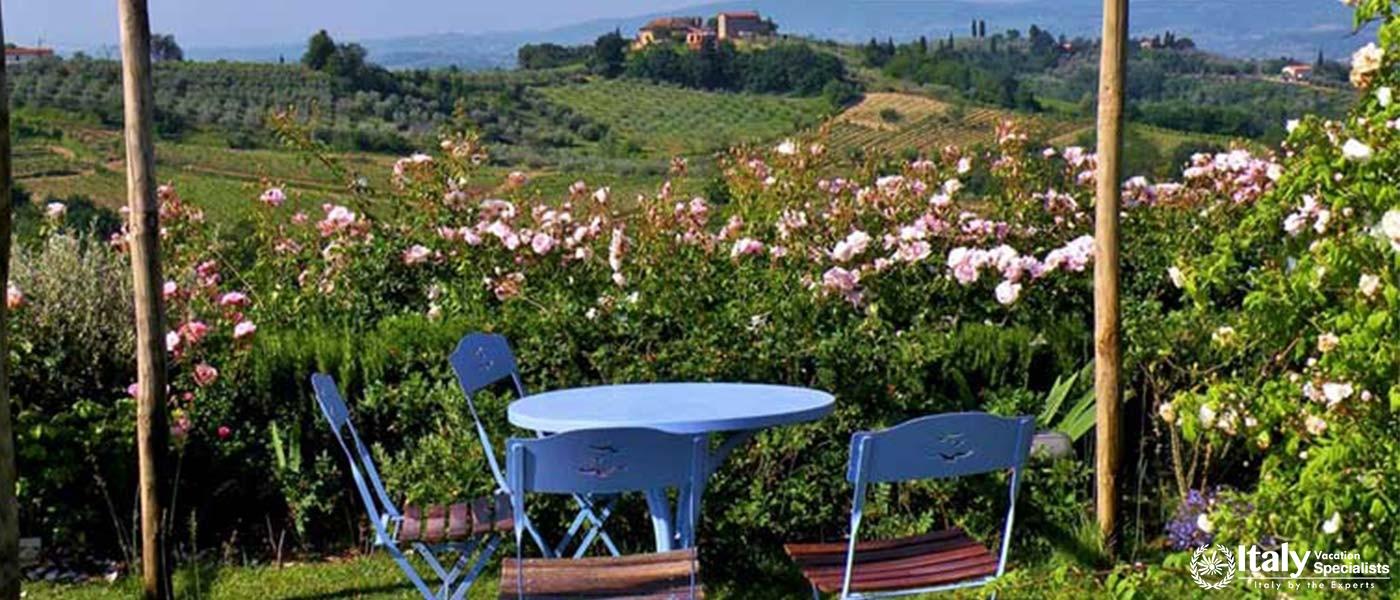 Cozy garden seating with vineyard view near Florence, Italy.