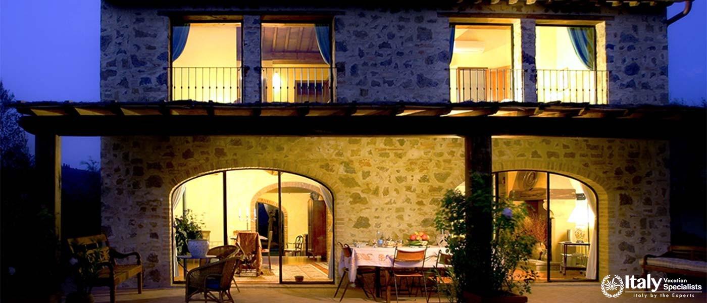 Stone villa illuminated at night near Florence, Italy.