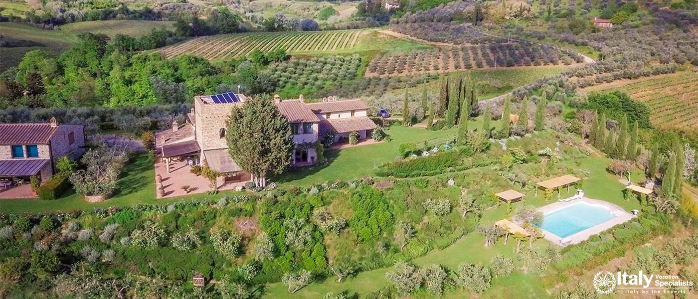 Aerial view of a beautiful countryside estate near Florence, Italy, featuring lush vineyards.