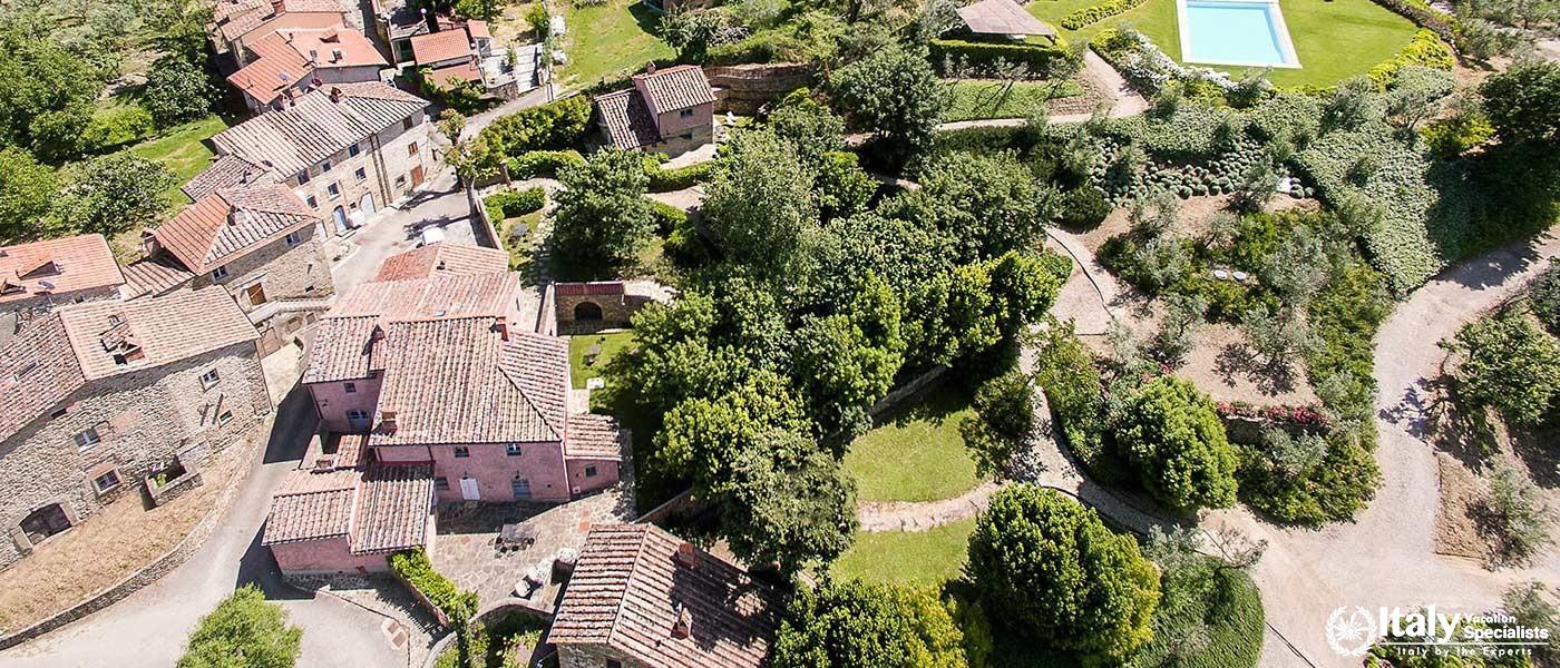View of villa grounds with garden paths and buildings.