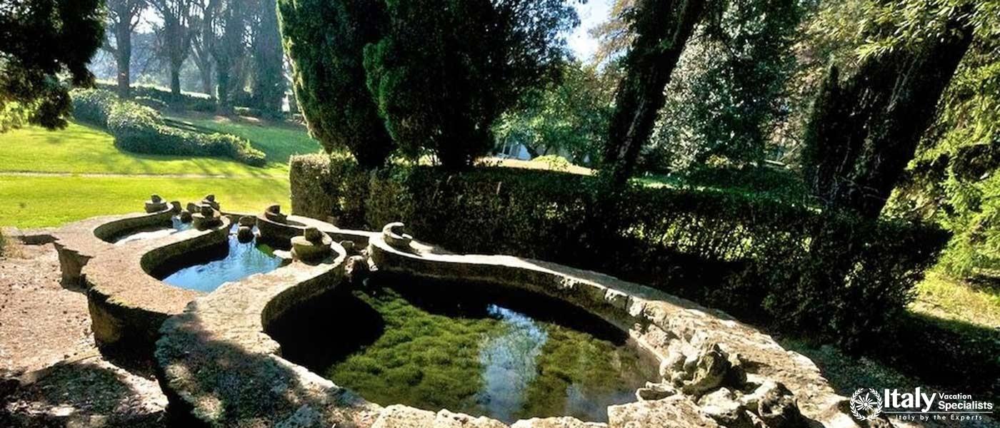 A serene garden with an enchanting fountain and lush greenery.