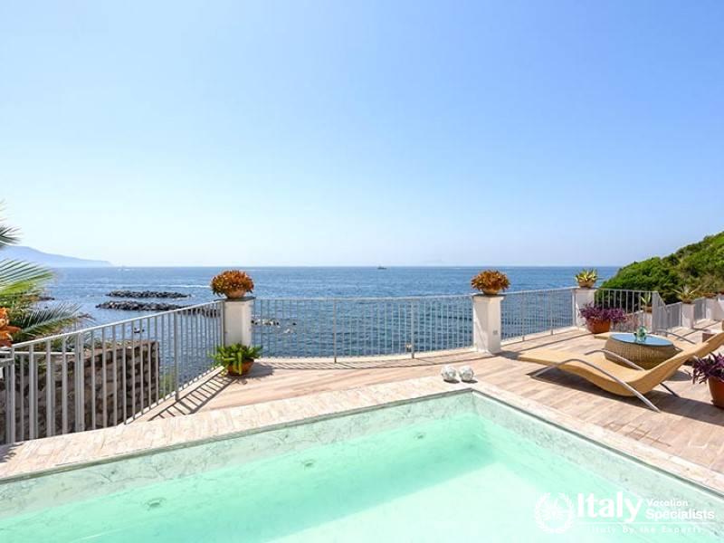 Refreshing pool overlooking the vast ocean horizon.