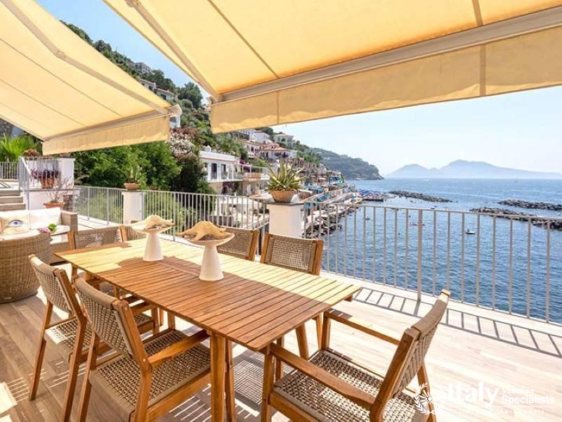 Outdoor dining area with a beautiful coastal view.